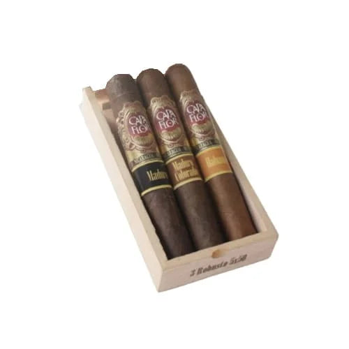 Three cigars in a wooden box with 'Capa Flor' branding on a white background