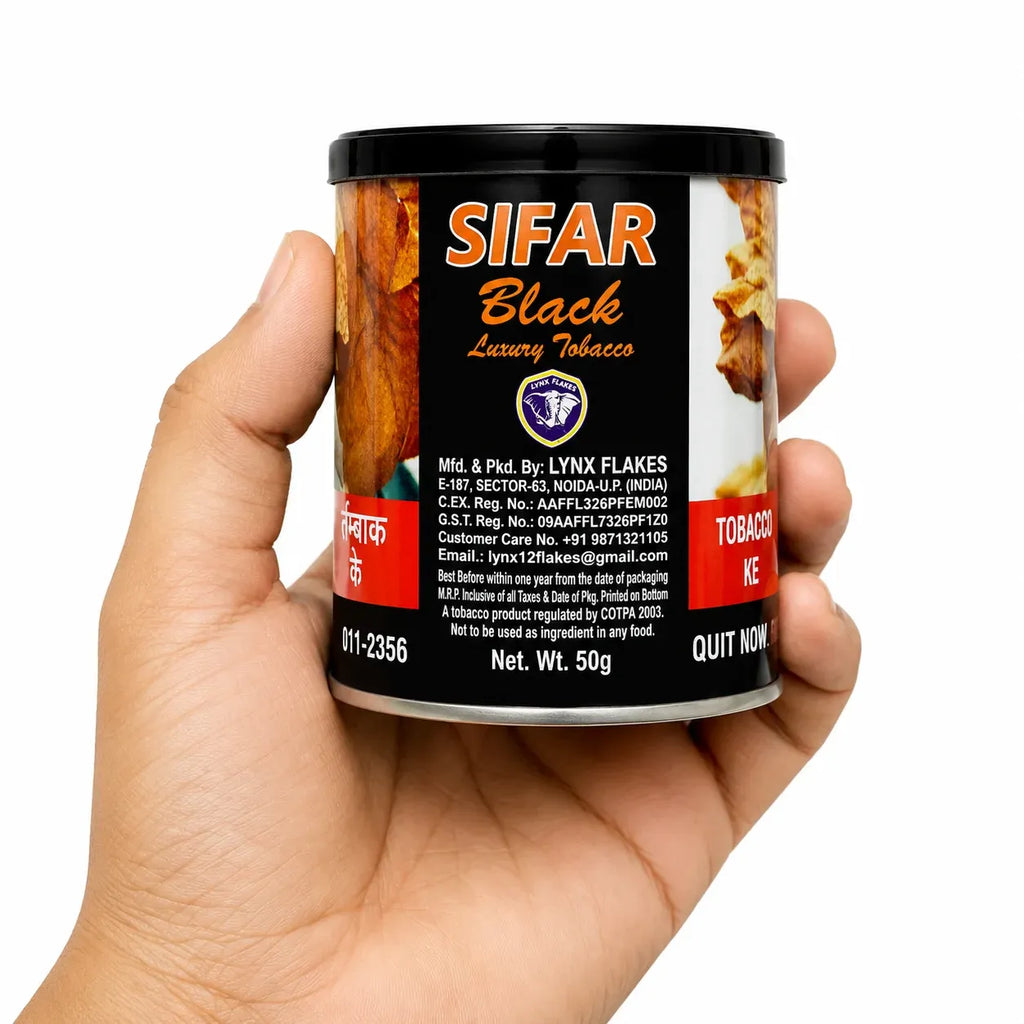 A hand holding a cylindrical tin of SIFAR Black Luxury Tobacco against a plain white background.